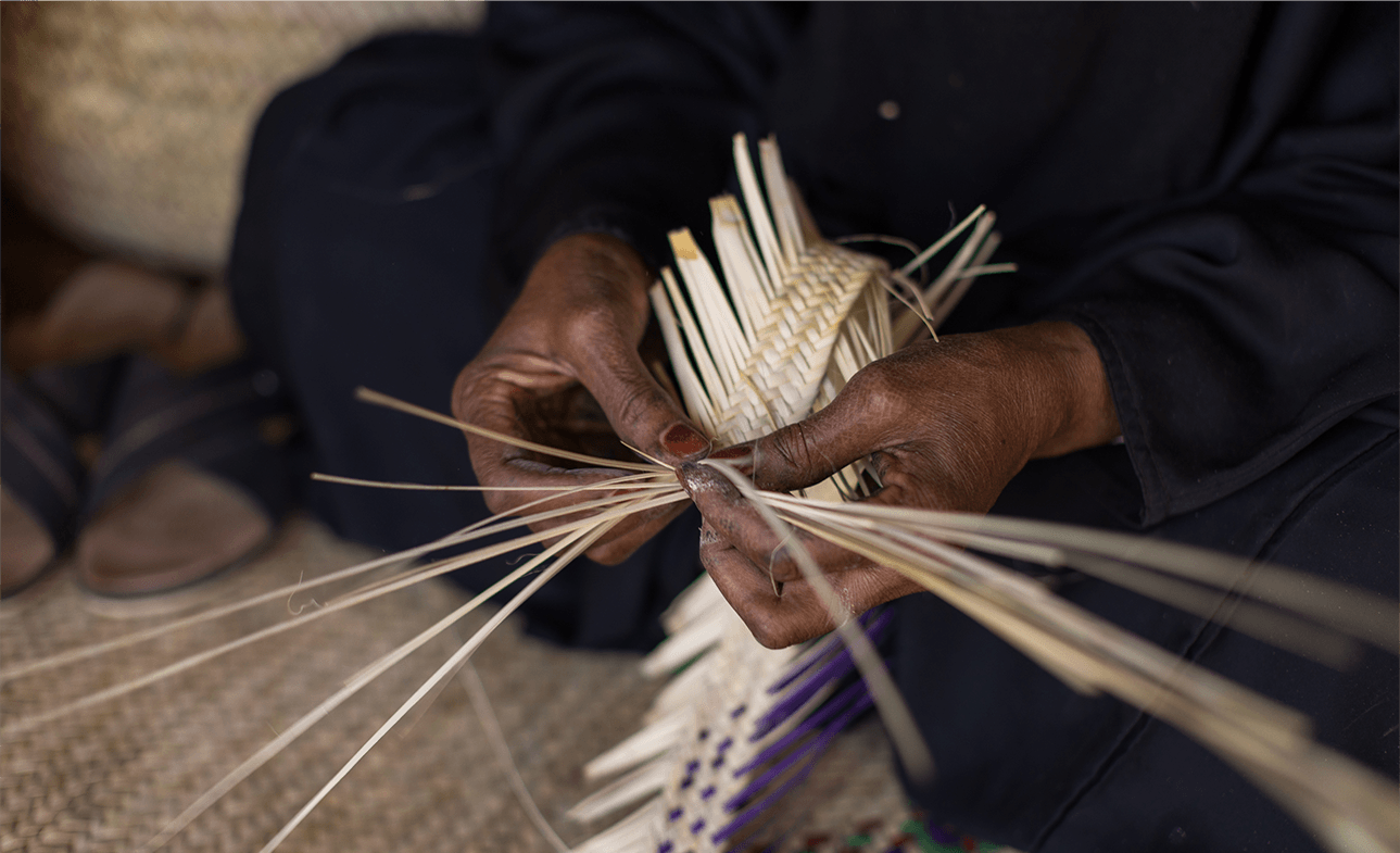 Artist working with palm tree fibers