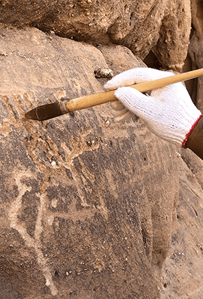 Cleaning with a brush during an archaeological excavation